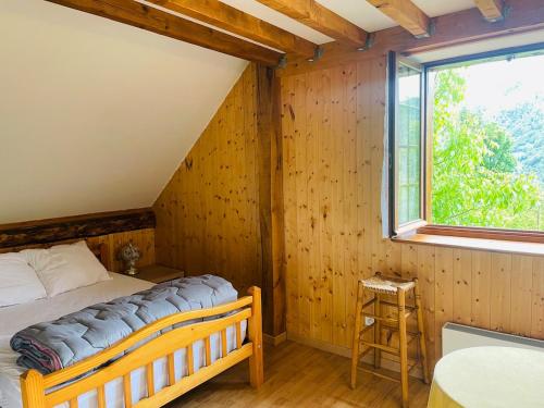 a bedroom with a bed and a window at Chalet individuel à Ustou 09 in Ustou