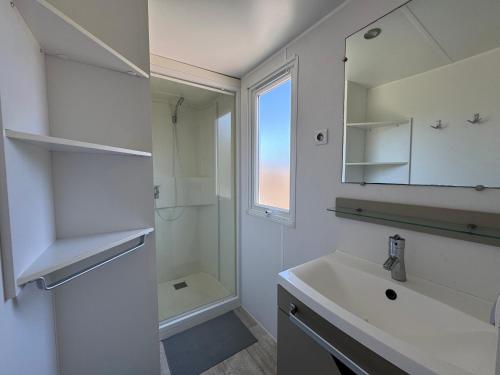 a bathroom with a sink and a mirror at Camping les Lauriers Roses in Fréjus