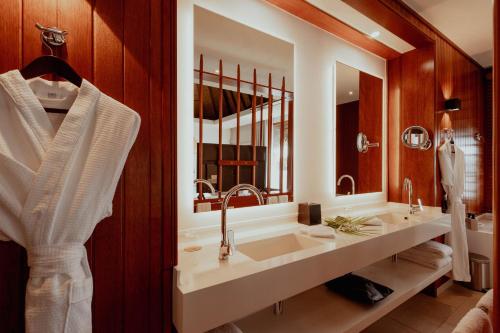 a bathroom with a sink and a mirror at Tahiti Lagoon Resort in Punaauia