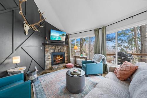 a living room with a couch and a fireplace at Round House in Beech Mountain