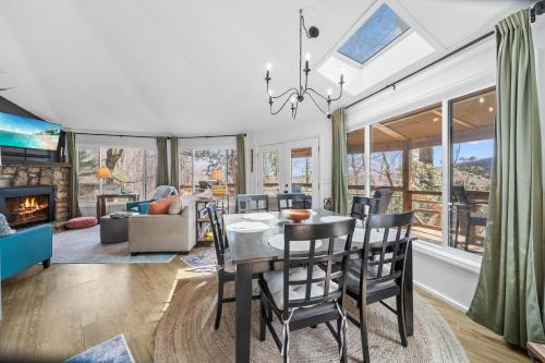 a dining room and living room with a table and chairs at Round House in Beech Mountain