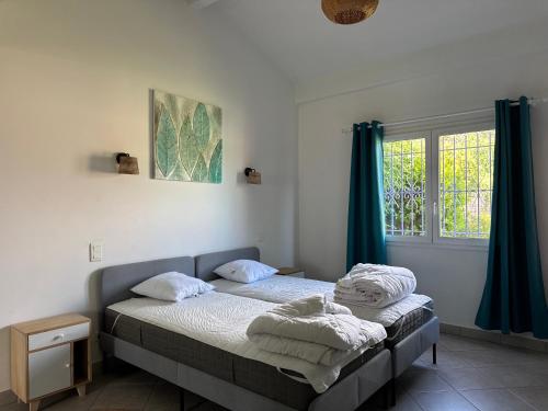 a bedroom with a bed and a window at Camping les Lauriers Roses in Fréjus