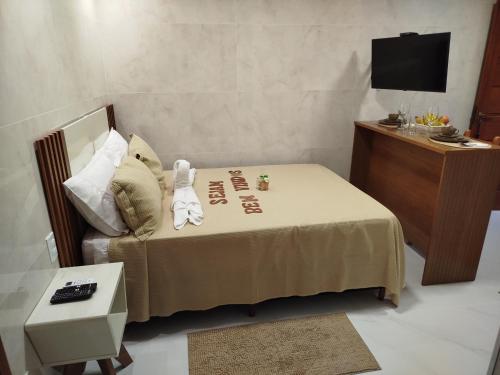 a small bedroom with a bed with a teddy bear on it at Flat Sognare Uno in Santa Teresa