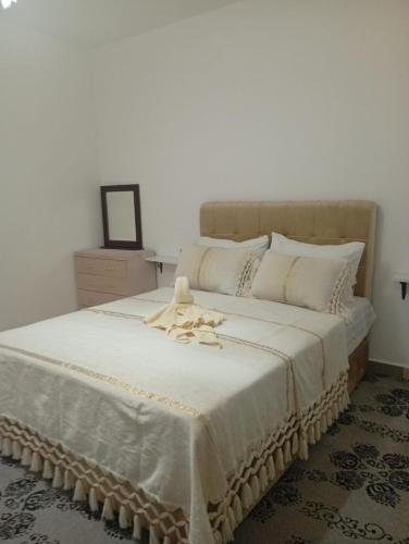 a bedroom with a large white bed with a towel on it at Dar Salima in Chefchaouen
