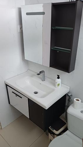 a bathroom with a sink and a mirror and a toilet at Riba Mar in Cidade Velha