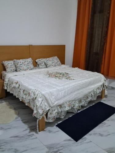 a bed with a white blanket and pillows on it at Riba Mar in Cidade Velha