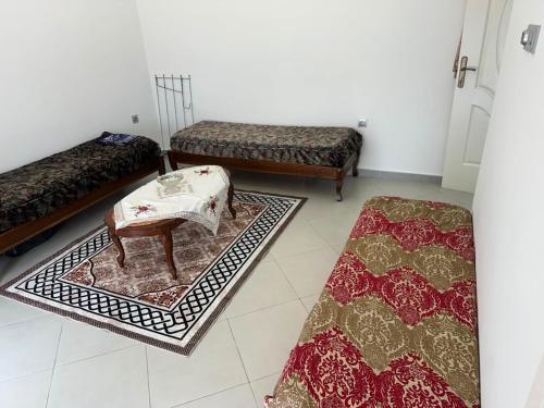 a living room with three rugs on the floor at Appartement in Jijel