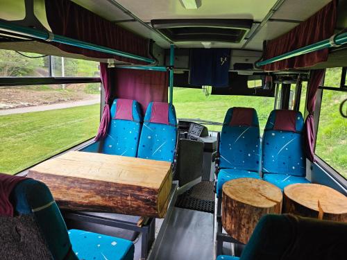 a bus with tables and chairs in the back at Bed in Bus in Kolárovice