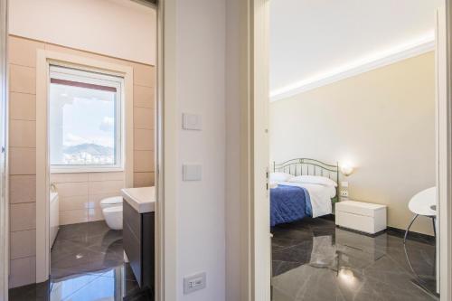 a bathroom with a bed and a toilet and a sink at Crescent Luxury Retreat - Seafront Apartment Scala E in Salerno
