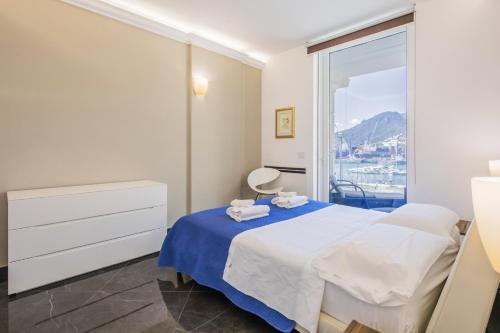 a bedroom with a bed and a large window at Crescent Luxury Retreat - Seafront Apartment Scala E in Salerno