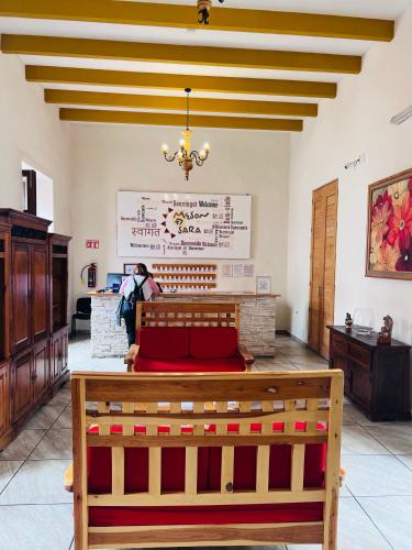 a church with a pew in the middle of a room at Hotel Meson de Sara in Querétaro