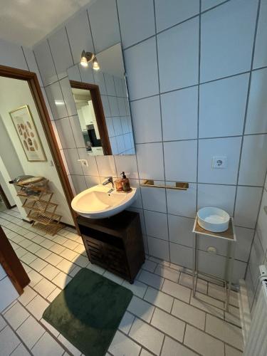 a bathroom with a sink and a toilet at Cozy & modern apartment in Willstätt in Willstätt