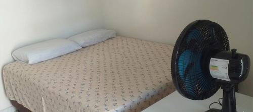 a bedroom with a bed with a fan on it at beach house in Pontal de Coruripe in Coruripe