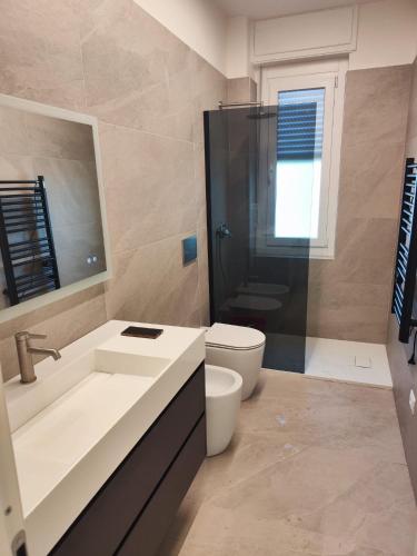 a bathroom with a toilet and a sink and a shower at La casa del sole in Trofarello