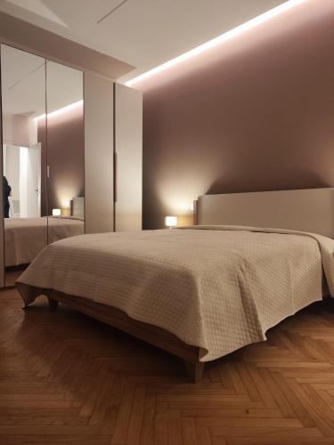 a bedroom with a large bed and a mirror at La casa del sole in Trofarello