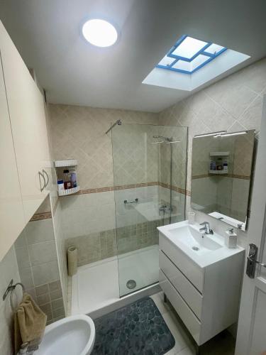 a bathroom with a shower and a sink and a toilet at C&M Dream House in Morro del Jable