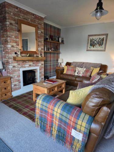 a living room with a couch and a fireplace at Tigh Na Mara in Furnace
