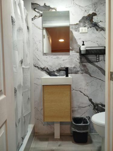 a bathroom with a sink and a mirror at Casa Marina Sotomayor in Santiago