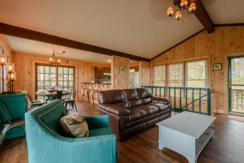 a living room with a couch and a table at Mountain Stay Chalet in Beech Mountain