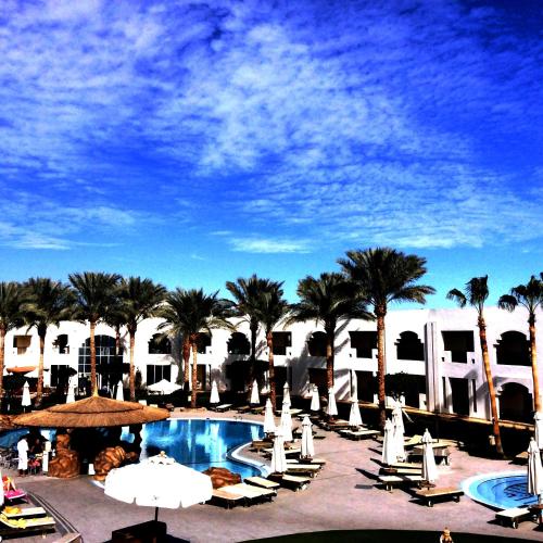 a view of a resort with a pool and palm trees at Xperience St. George Sharm El Sheikh in Sharm El Sheikh