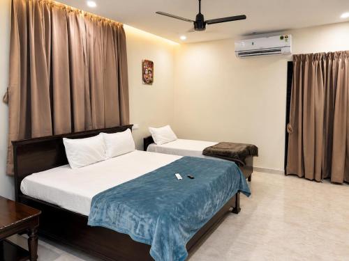 a hotel room with two beds and a window at JK Suites in Rāmachandrapuram