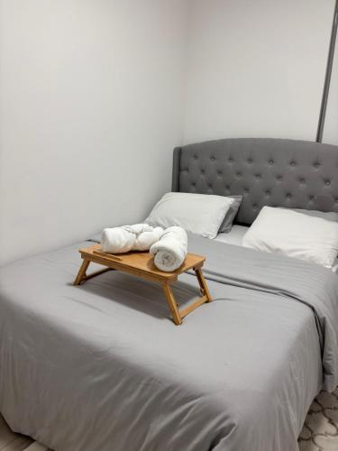a bed with a tray with towels on it at Cozy 1 bed and 1 bath in Surrey