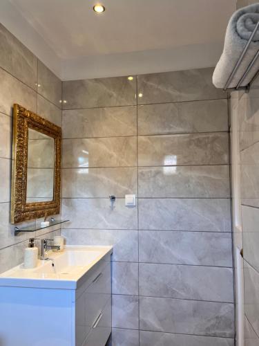 a bathroom with a sink and a shower at GREEN and BLUE VILLA in Glykadi