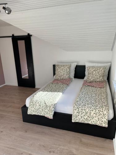 a bedroom with two beds with pillows on it at Stylish & modern Flat with large Sun Balcony in Bad Peterstal