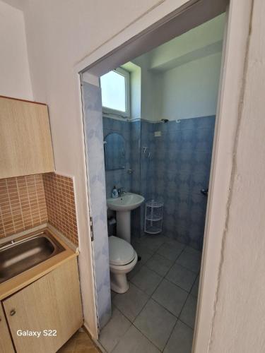 a bathroom with a toilet and a sink at Sunset Panorama Residence in Vlorë