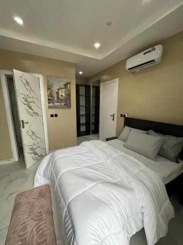 a bedroom with a large white bed in it at Pcg Homes in Lagos