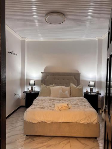 a bedroom with a large bed with two night stands at The Rose Garden in Georgetown