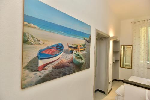 a painting of three boats on the beach at Mezza Galea in Vernazza