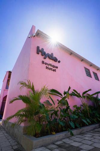 a building with a hico sign on the side of it at Hyde Boutique Hotel in Kuta Lombok