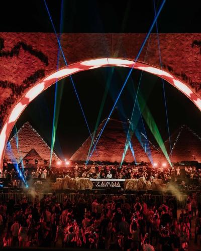 a crowd of people standing in front of a stage at Farida Pyramids inn& Jacuzzi in Cairo