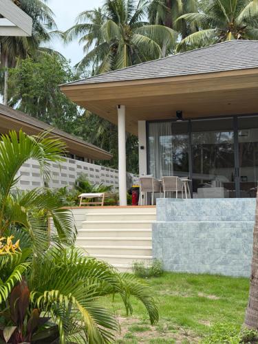 a house with a porch and a patio at Wave Villa New 2BR Pool Villa in Ko Phangan