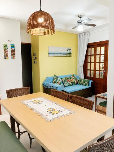 a dining room with a table and a couch at Residencial Villa Jeri - AP with balcony, optional BREAKFAST in Jericoacoara