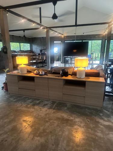 a living room with two lamps on a table at Loft at Rawaï Beach in Nai Harn Beach