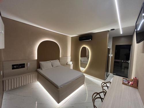 a bedroom with a bed and a tv in a room at Ellus Motel in Juazeiro do Norte