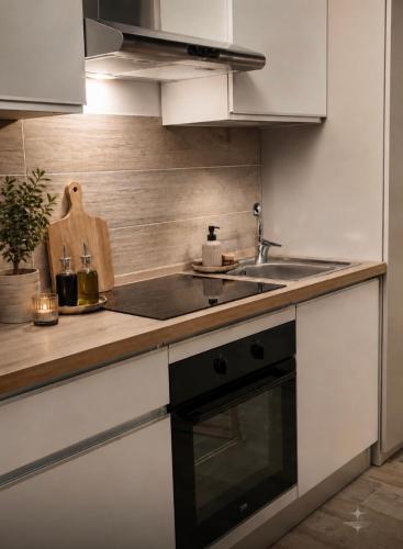 a kitchen with a sink and a stove at Vega Suite in Bracciano