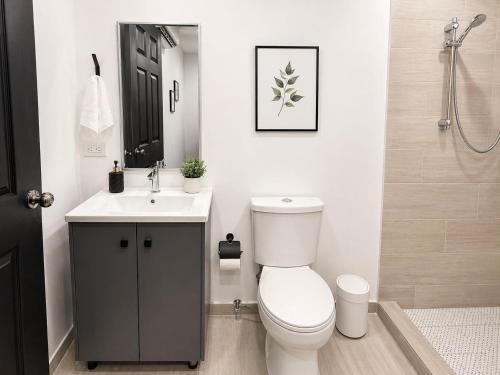 a bathroom with a toilet and a sink and a shower at Hostal Boutique Zona Rosa - San Benito in San Salvador