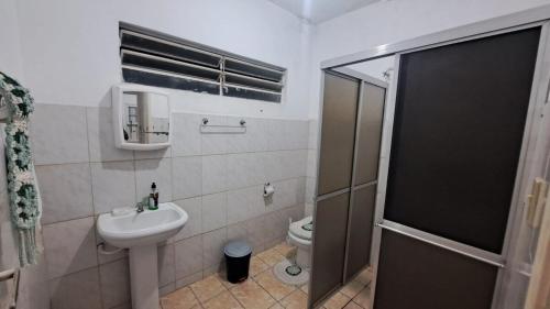 a small bathroom with a sink and a toilet at Morada Santa Rita in Aparecida