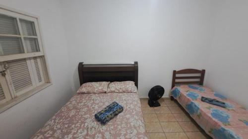 a bedroom with two beds and a window at Morada Santa Rita in Aparecida