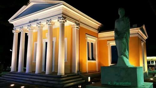 a building with a statue in front of it at Alkyonides Boutique Hotel in Kremasti