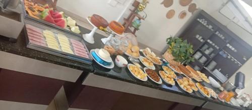 a counter topped with lots of different types of food at Querência Pantaneira in Miranda