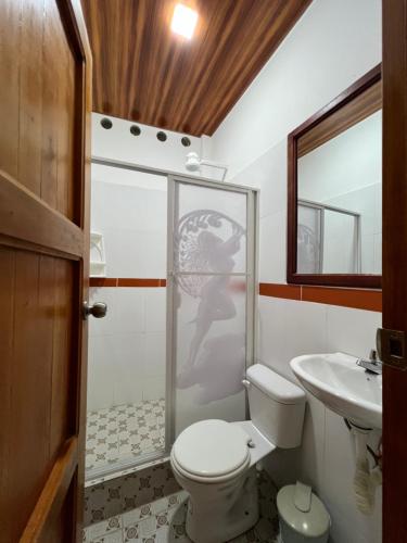 a bathroom with a toilet and a sink at Sisa Lodge in Tena