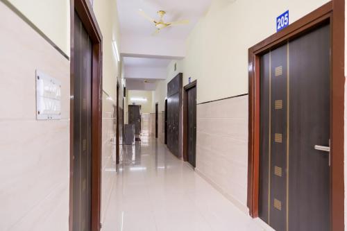 a hallway with a row of doors in a building at Super Hotel O Viraj Deluxe Narela in Delhi
