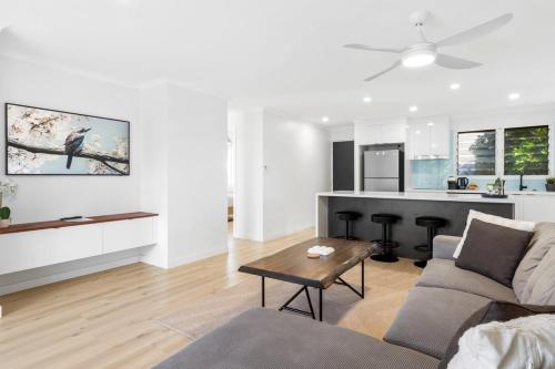 a living room with a couch and a table at Azure beachside Escape in Marcoola