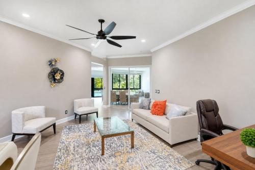 a living room with a couch and chairs and a ceiling fan at The Riverview Estates in Riverview