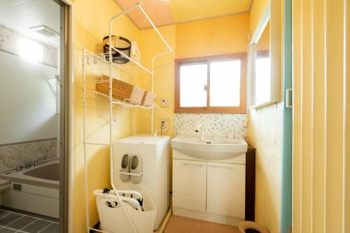a small bathroom with a sink and a toilet at Joy House in Matsumoto