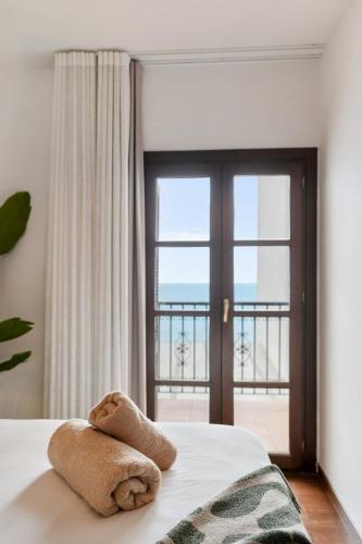 a bedroom with a bed with a view of the ocean at Casa Carpa Andalucia IV Carabeo Playa in Nerja